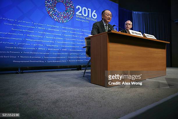 World Bank President Jim Young Kim speaks as Communications Advisor John Donnelly listens during a news conference April 14, 2016 in Washington, DC....