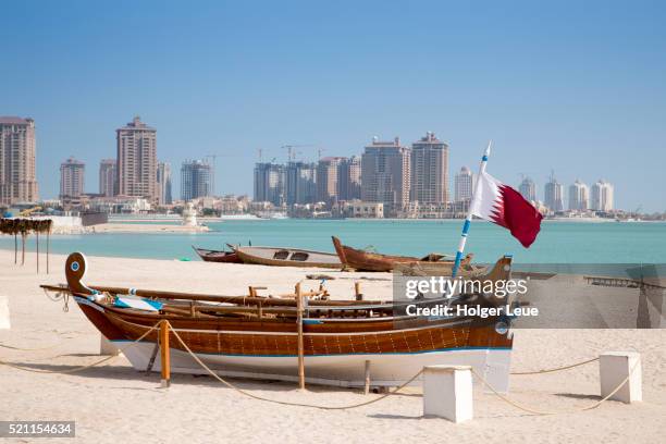 boat on beach near katara cultural center with the pearl qatar development in distance - the pearl qatar bildbanksfoton och bilder