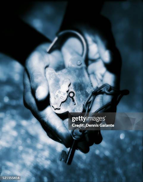 hands holding lock - slave holder stock pictures, royalty-free photos & images