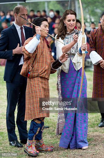Catherine, Duchess of Cambridge and Prince William take part in archery at Thimphu's open-air archery venue on April 14, 2016 in Thimphu, Bhutan.