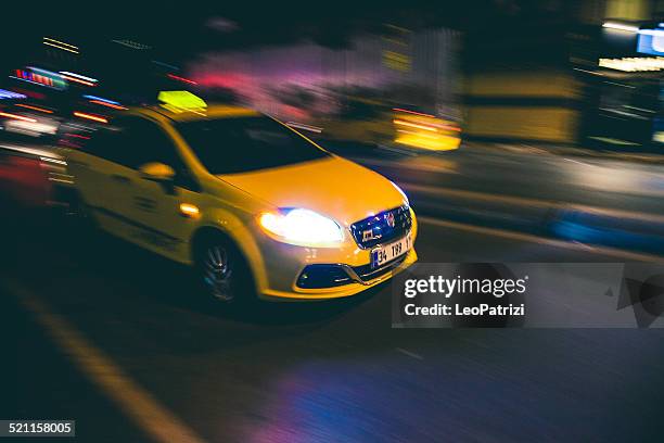 fast speed yellow taxi in the city traffic at night - yellow taxi stock pictures, royalty-free photos & images