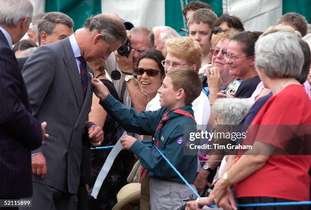 Prince Charles Being Given A Badge By A Boy Scout At The Sandringham Flower Show.