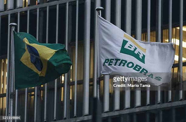 Brazilian flag and a Petrobras flag fly in front of Petrobras headquarters on April 13, 2016 in Rio de Janeiro, Brazil. A massive corruption scandal...