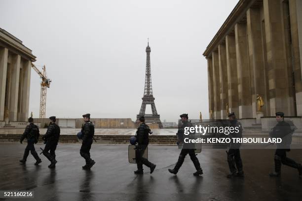 The Eiffel Tower is seen in the background as French gendarmes, part of Operation Sentinelle, patrol near the Musee de l'Homme in Paris on April 14...