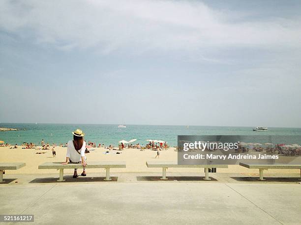 girl sitting in front of the beach - barceloneta beach bildbanksfoton och bilder
