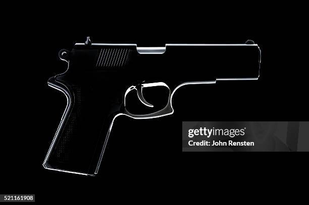 silhouette of handgun - vuurwapen stockfoto's en -beelden