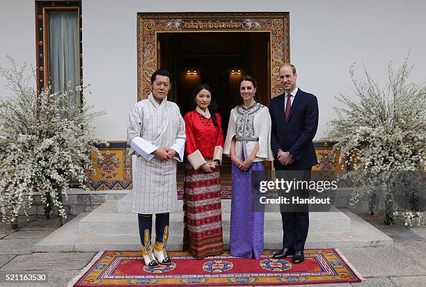 In this handout photo provided by Bhutan Royal Office, Prince William, Duke of Cambridge and Catherine, Duchess of Cambridge pose with King Jigme...