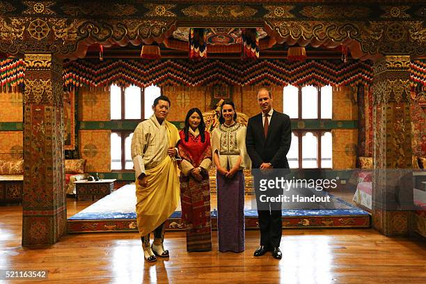 In this handout photo provided by Bhutan Royal Office, Prince William, Duke of Cambridge and Catherine, Duchess of Cambridge pose with King Jigme...