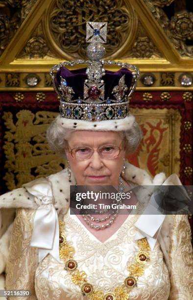 Queen Elizabeth Ll At The State Opening Of Parliament Seated On A Throne In The House Of Lords In The Palace Of Westminster And About To Make Her...