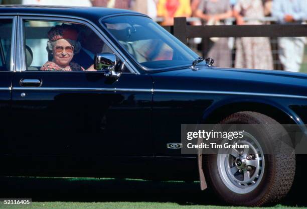 Queen Elizabeth II Driving Herself In Her Daimler Jaguar Car As She Arrives To Watch Polo At Smiths Lawn, Windsor.