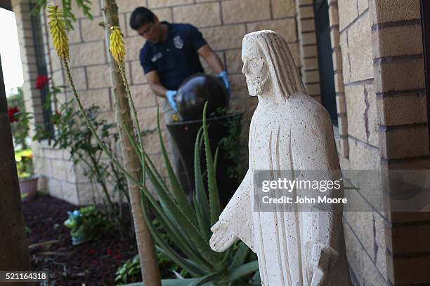 City environmental health specialist Gerardo Valdez checks for mosquitos in standing water on April 14, 2016 in McAllen, Texas. The city is catching...