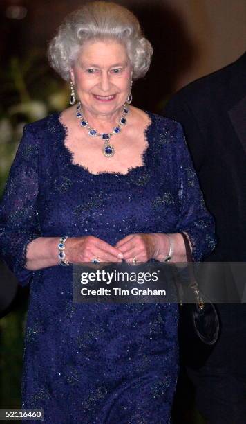 Queen Elizabeth II Happy And Smiling As She Leaves The Ritz Hotel After A Party To Celebrate Her Golden Jubilee Year. She Wore A Suite Of Sapphire...