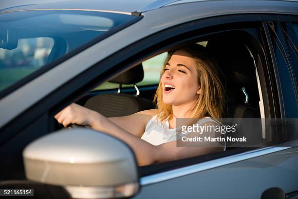 singing in car - girl singing stock pictures, royalty-free photos & images