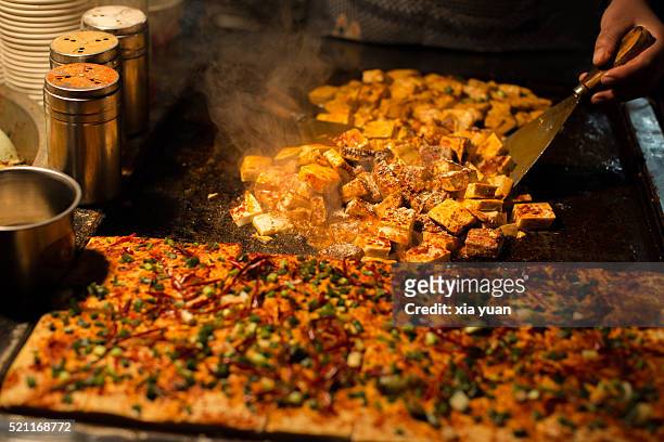 grilled stinky tofu on the night market of the muslim street,xian city,china - xian stock-fotos und bilder