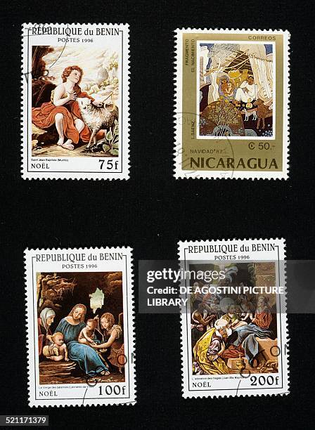 Postage stamps with Christmas-themed paintings: left and bottom right, St. John the Baptist as a Child by Murillo, The Madonna and Child with Saint...