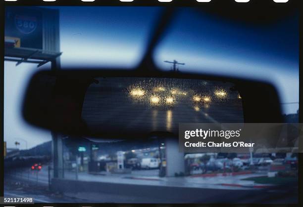 rainy highway reflected in automobile mirror - rear view mirror stock pictures, royalty-free photos & images
