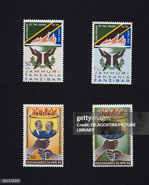 Postage stamps from the series commemorating the 2nd anniversary of the Republic of Tanzania depicting a burning brazier, bottom, a torch inset with...