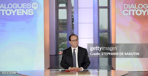French President Francois Hollande is seen in a studio set-up by France 2, a public television station, at the Musee de L'homme as he faces...