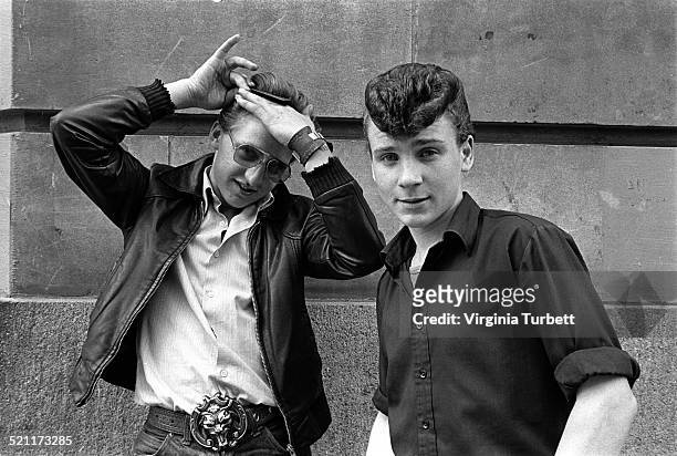 Two rockabilly fans wearing retro Teddy Boy fashions and with prominent quiff hairstyles, London, 1980s.