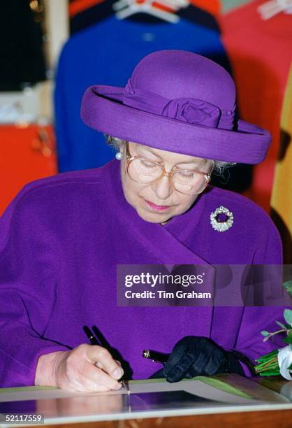 Queen Elizabeth II Writing During A Visit To Winchester