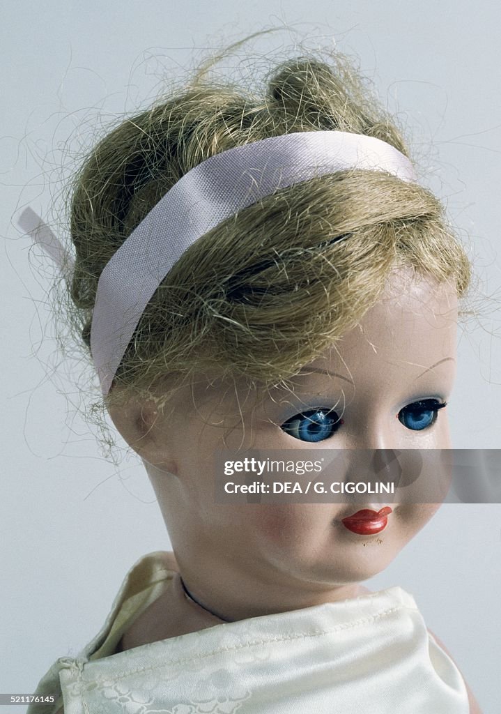 Bisque doll with ribbon in her hair. detail.