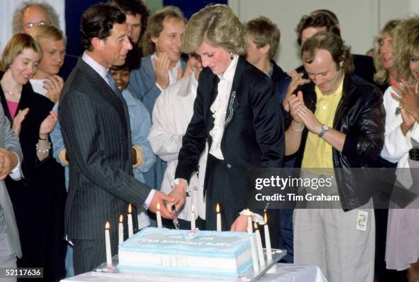 Princess Diana And Prince Charles Cutting A Cake To Celebrate Ten Years Of The Prince's Trust Concert At Wembley. The Singer And Musician Phil...
