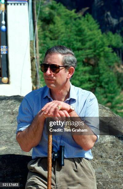 Prince Charles, With Binoculars And Shepherd's Crook Walking Stick, Resting By A Prayer Hut During His Trek Through The Himalayas On His Way To The...