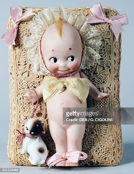 Kewpie doll with Doddledog, celluloid doll, made by Kewpie. United States of America, 20th century. United States