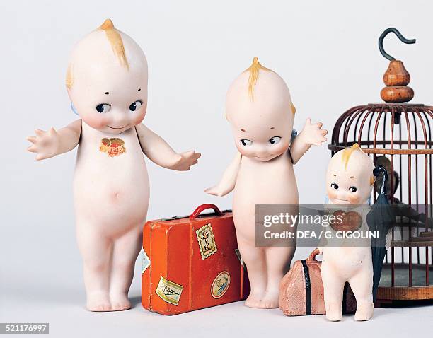 Kewpie dolls with suitcase and bird cage, celluloid dolls made by Kewpie. United States of America, 20th century. United States