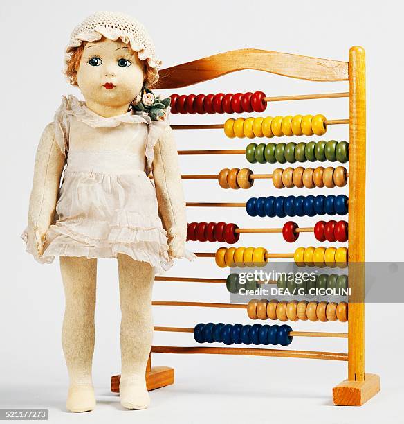 Doll with wooden abacus, made by Furga, 1930s. Italy, 20th century. Canneto Sull'Oglio, Museo Del Giocattolo Giulio Superti Furga Italy