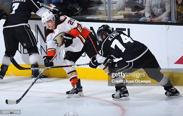 Mike Santorelli of the Anaheim Ducks passes the puck against Dwight King of the Los Angeles Kings on April 7, 2016 at Staples Center in Los Angeles,...