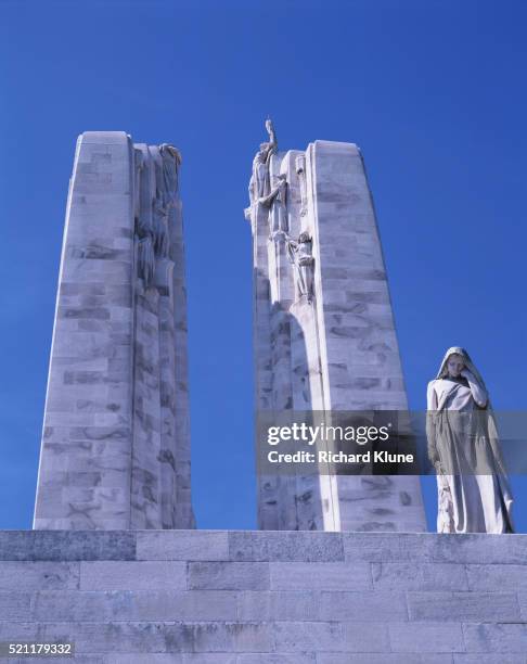detail showing pylons and a sculptural figure representing canada on the canadian national vimy memorial - battle of arras stock pictures, royalty-free photos & images