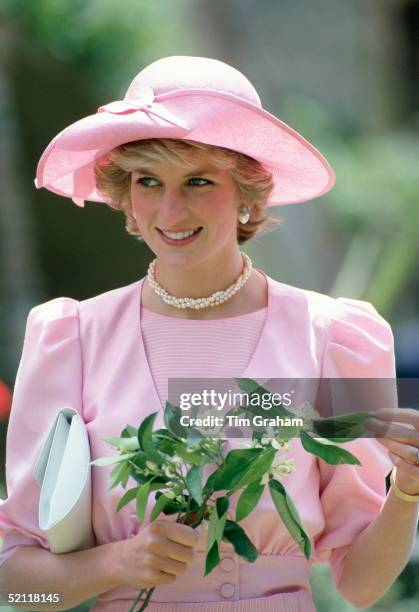 Princess Diana In Sicily Holding Orange Blossom Flowers Wearing An Outfit Designed By Fashion Designer Catherine Walker And A Hat By Milliner John...