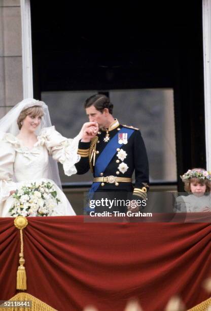 Prince Charles Kisses The Hand Of His New Wife, Diana, Princess Of Wales On The Balcony Of Buckingham Palace. She Is Wearing A Wedding Dress Designed...