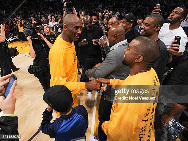 Kanye West greets Kobe Bryant at a basketball game between the Utah Jazz and the Los Angeles Lakers at Staples Center on April 13, 2016 in Los...