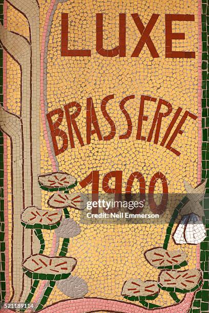 ornate tile work on parisien cafe, france - café parisien stockfoto's en -beelden