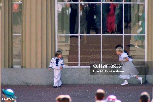 Prince William, Dressed As A Pageboy, Playing With Lady Davina Windsor In The Grounds Of Buckingham Palace Following The Wedding Of Sarah Ferguson...