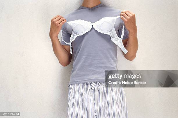 young man holding bra - men wearing bras photos stock pictures, royalty-free photos & images