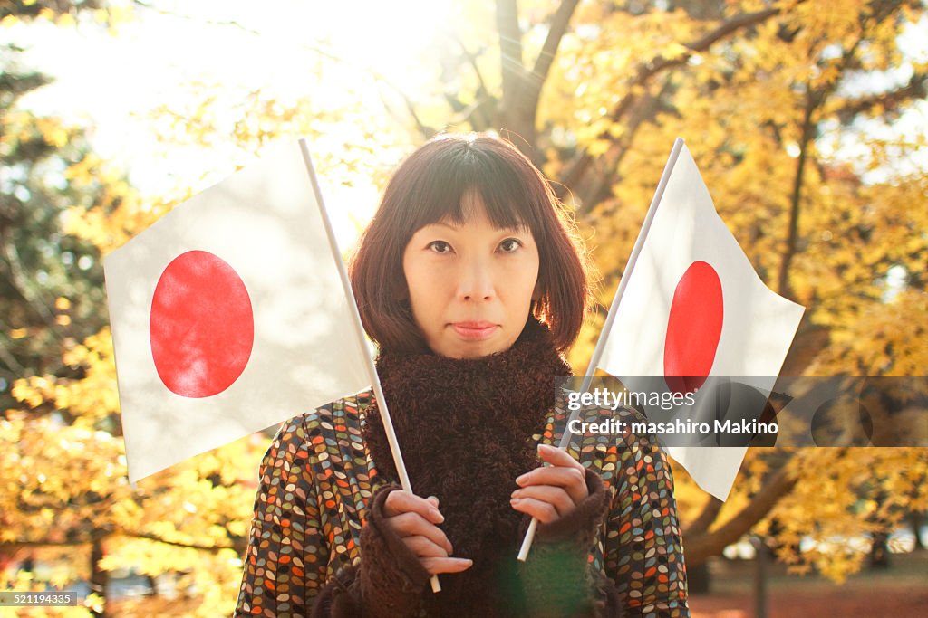 Woman Holding National Flags of Japan