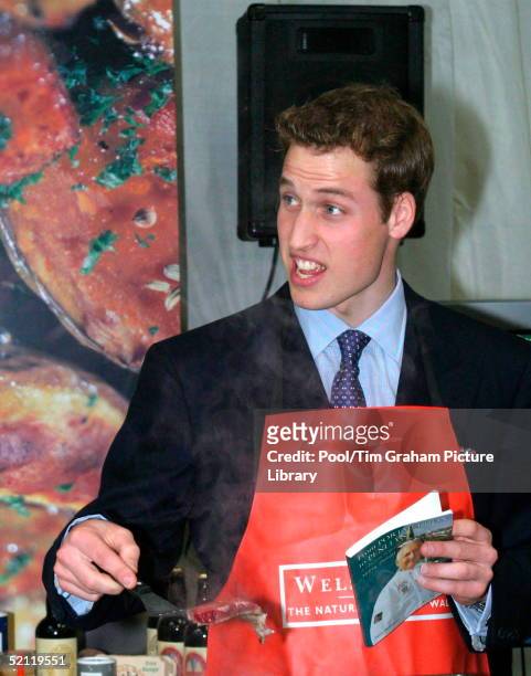 Prince William Holds A Cookery Book By Melvyn Thomas As He Takes Part In A Cookery Demonstration At The Anglesey Food Fair At The Anglesey...
