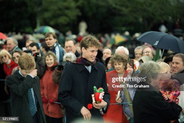 Royal Family Attending Christmas Day Service At Sandringham Church - Prince William, Carrying Presents Given To Him By People In The Crowd, Walking...