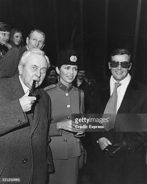 Former Prime Minister Harold Wilson meets American actress Barbara Bach and British actor Roger Moore at Pinewood Studios, UK, on the set of the...