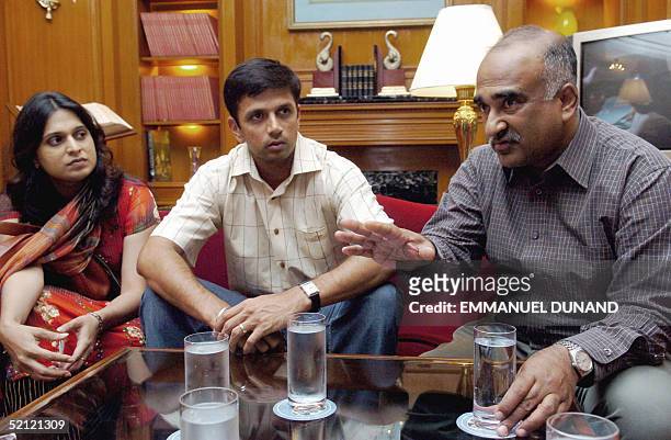 Ashok Alexander talks with Indian cricket star Rahul Dravid and his wife Vijeeta in Bangalore, 19 January 2005. Alexander, former highly-paid...