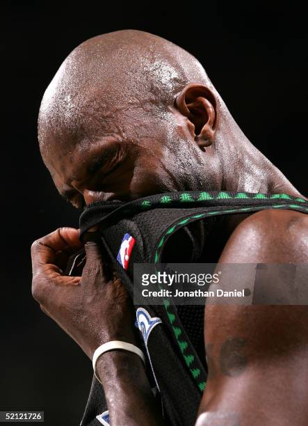 Kevin Garnett of the Minnesota Timberwolves wipes sweat from his face during a game against the Milwaukee Bucks on February 1, 2005 at Bradley Center...