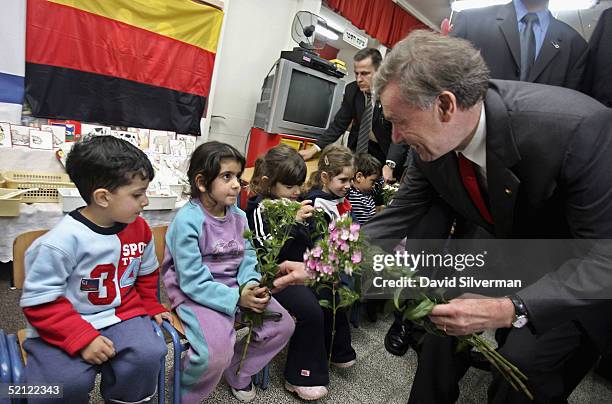German President Horst Koehler distributes flowers to the children he received them from when they welcomed him at Lilach kindergarten, on February...