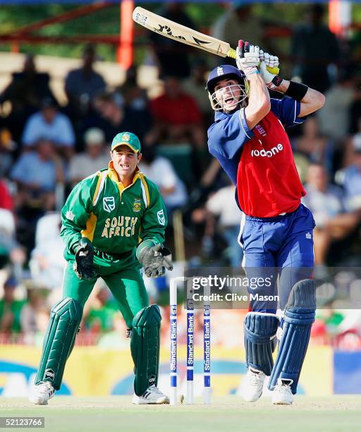 Kevin Pietersen of England on his way to a century watched by Mark Boucher of South Africa during the second one day international match between...