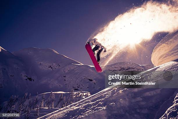snowboarder jumps into the sun - snowboard jump bildbanksfoton och bilder