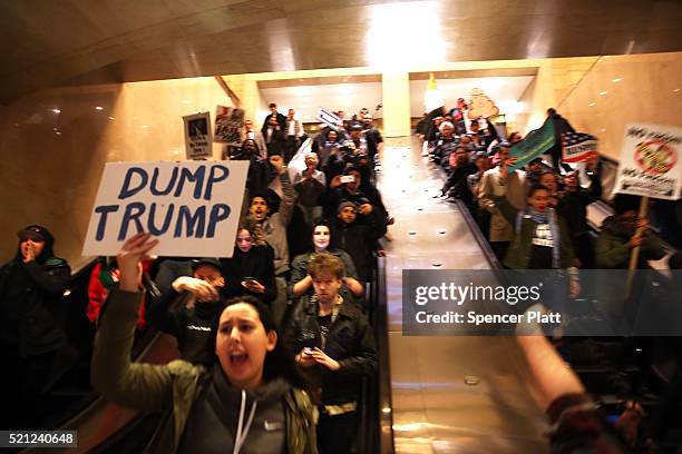 Hundreds of protesters and activists march through Grand Central Terminal during a demonstration near a midtown hotel which is hosting a black-tie...