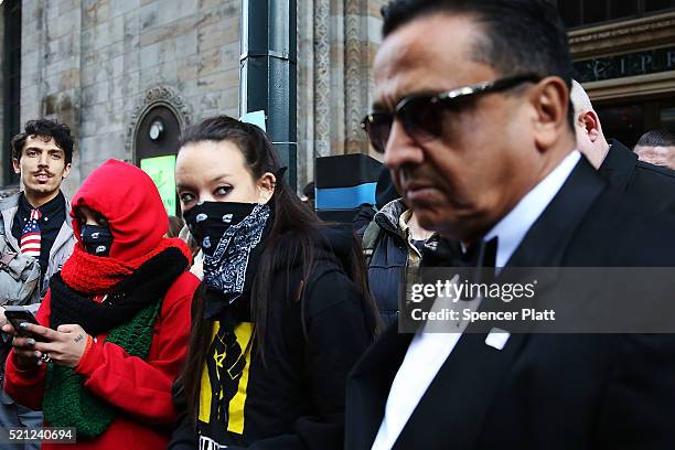 Attendees to a Republican fund-raiser walk by protesters and activists outside of a midtown hotel which is hosting a black-tie event for the state...