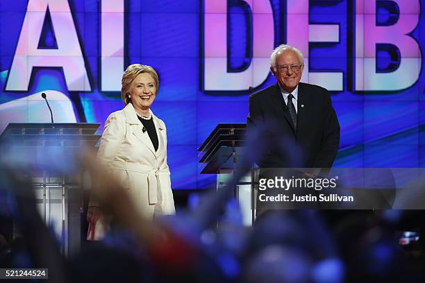 Democratic Presidential candidates Hillary Clinton and Sen. Bernie Sanders stand on stage during the CNN Democratic Presidential Primary Debate at...